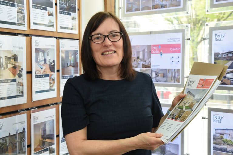 Anita Emmott preparing an auction property brochure